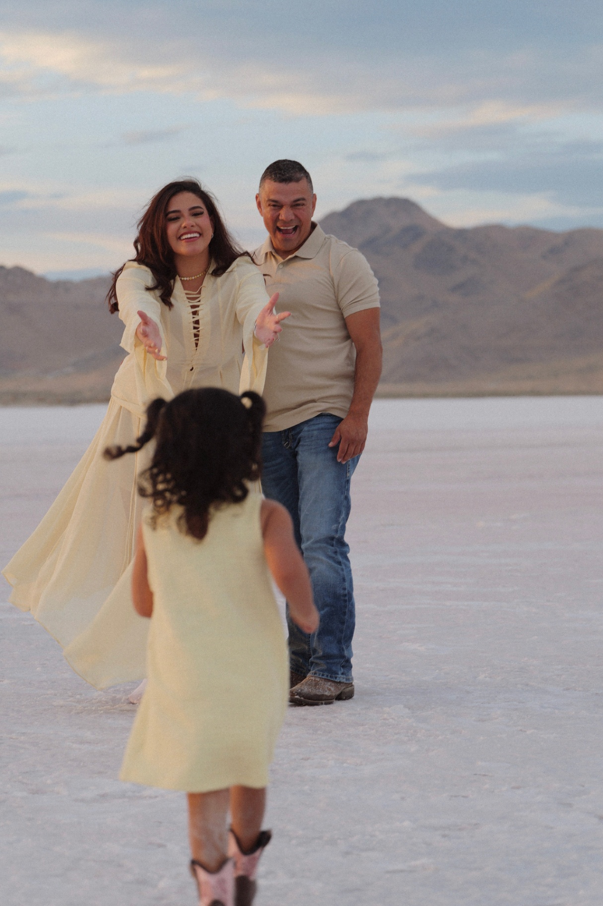 Family running to their daughter on the salt flats